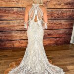 White lace wedding dress with beaded back and fringe on a woman
