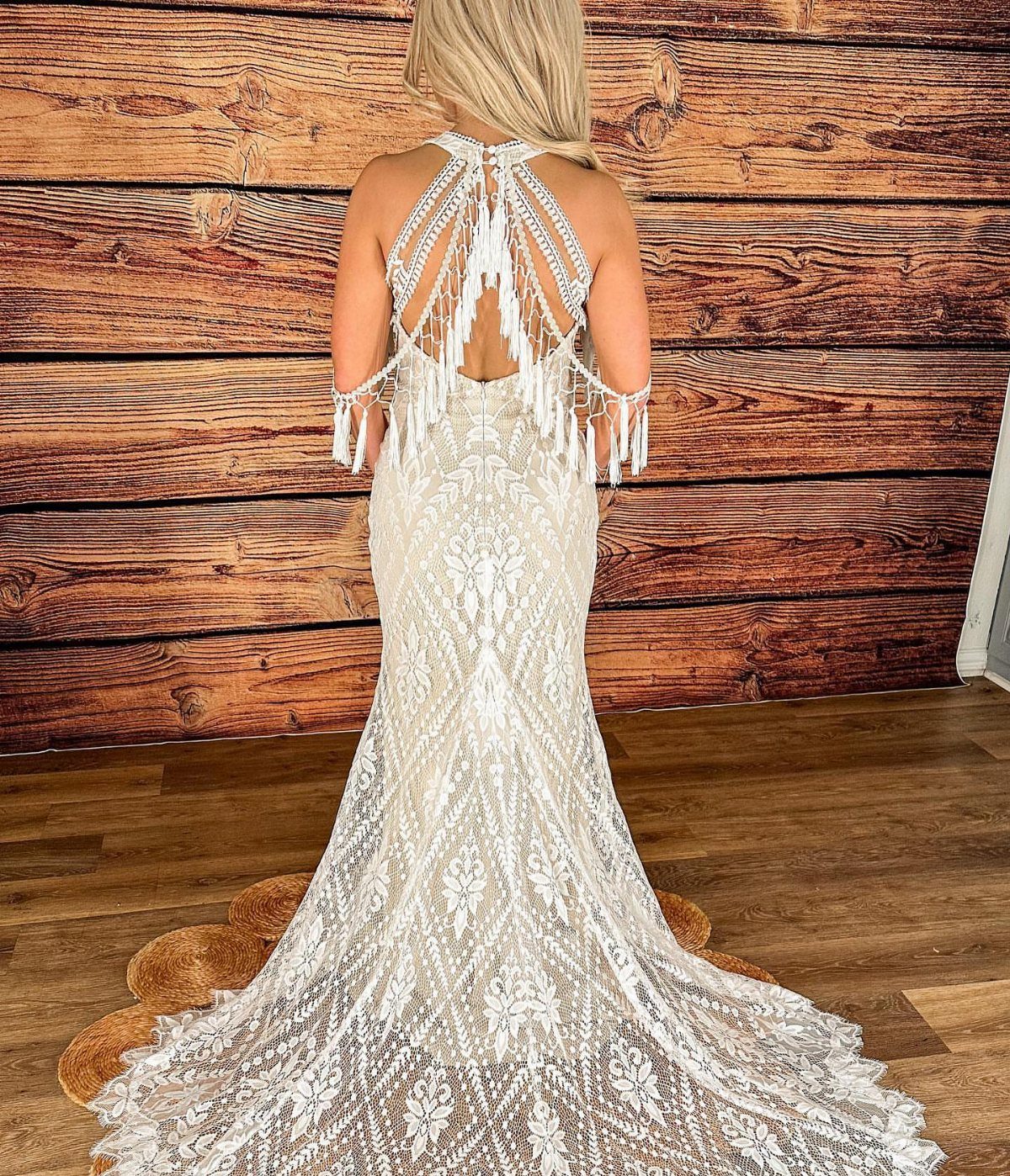 White lace wedding dress with beaded back and fringe on a woman