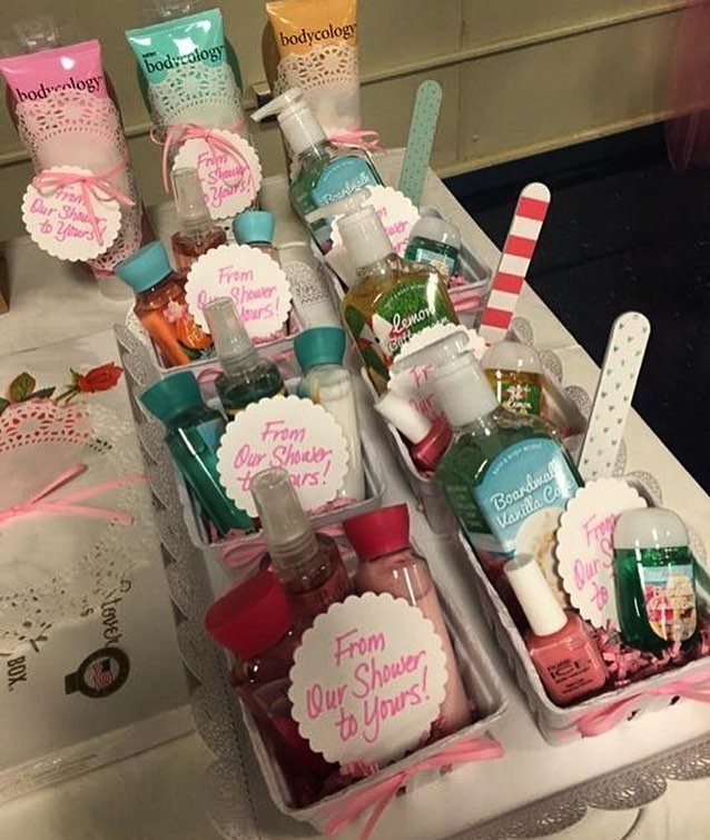 Beauty product gift baskets with pink ribbons and bridal shower tags for guests.