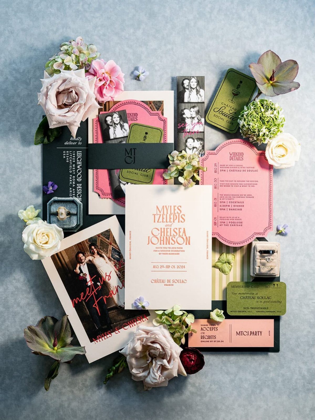 Wedding invitation suite with die-cut pink cards, black accents, and fresh floral arrangements.