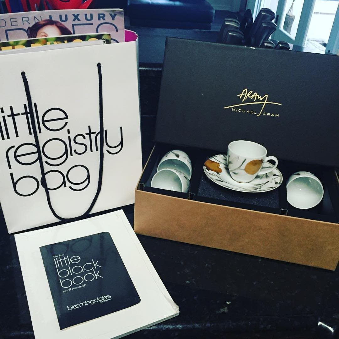 Wedding registry gift set with a white bag, tea set, and black book.