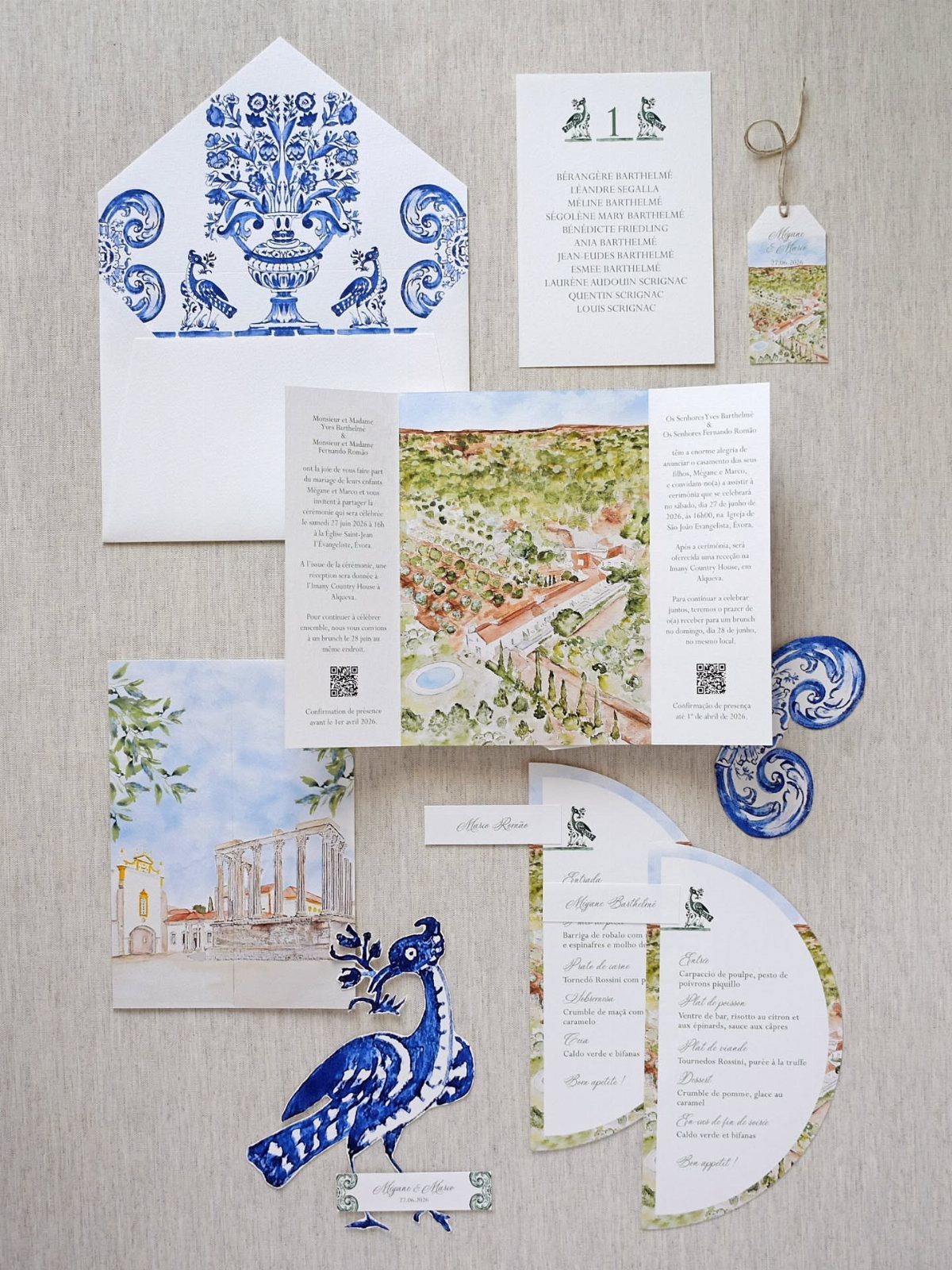Wedding invitation suite with blue floral patterns and watercolor landscape paintings.