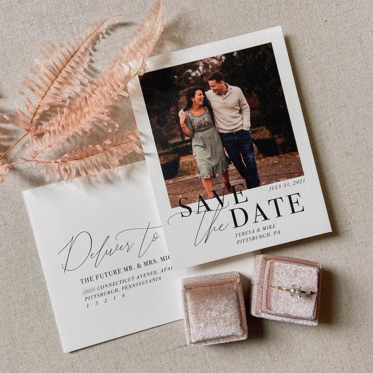 Polaroid style save the date card with a couple, envelope, and velvet ring boxes.