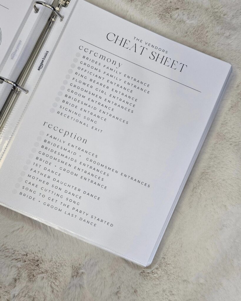 Wedding planning cheat sheet in a binder on a white fluffy background
